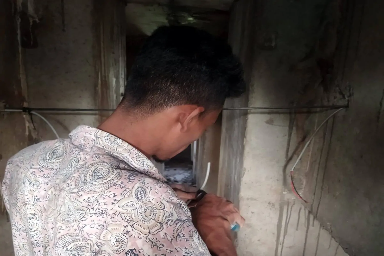 Technician performing CCTV camera wiring installation work at Kalshi Flyover project