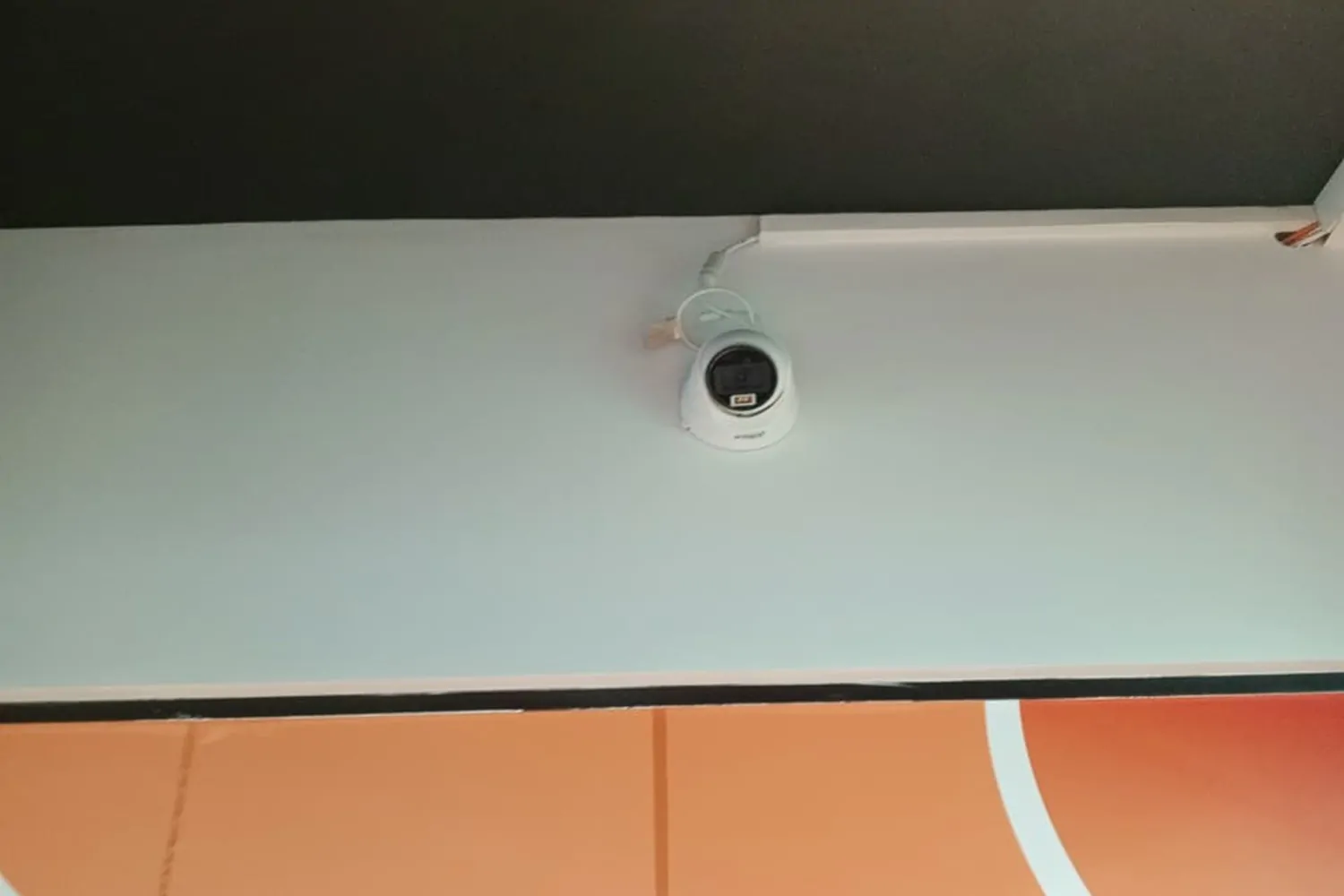 A professionally installed white Dahua eyeball dome security camera mounted